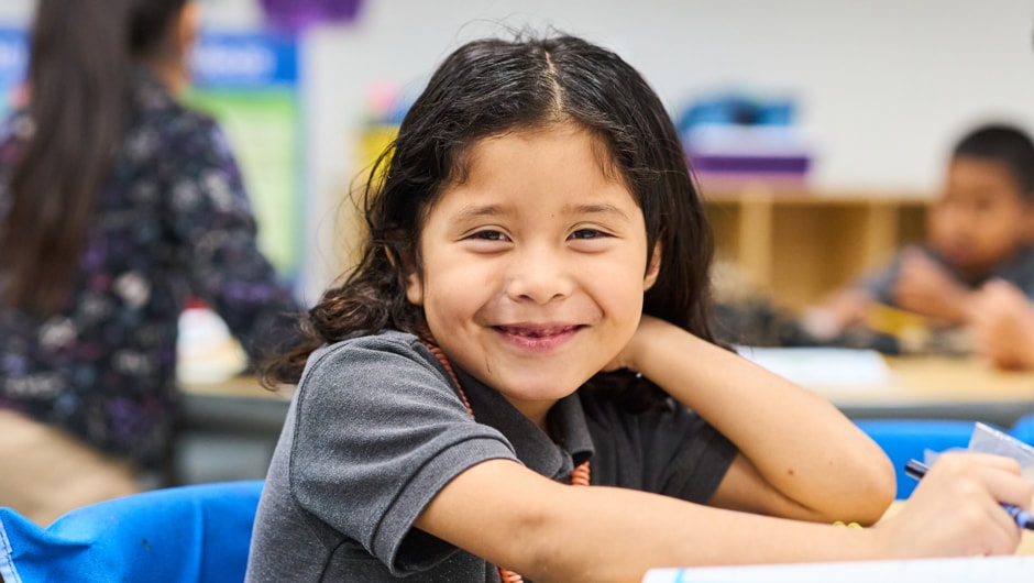 Student smiling in a classrooom