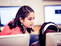a woman looking at a computer