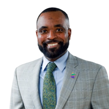 Man in a grey suit in front of a white background