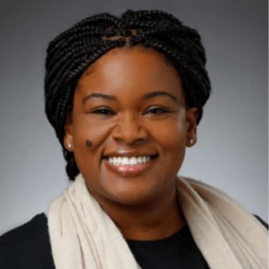 women with braids pulled back wearing a white scarf on top of black top