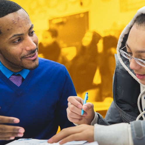 Student and teacher doing work in class