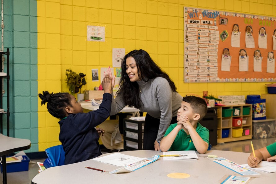 Teacher high fiving student