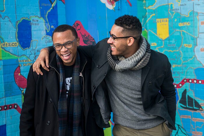 Tamir Harper (left) is a high school senior. Sterling Grimes (right) teaches high school English.
