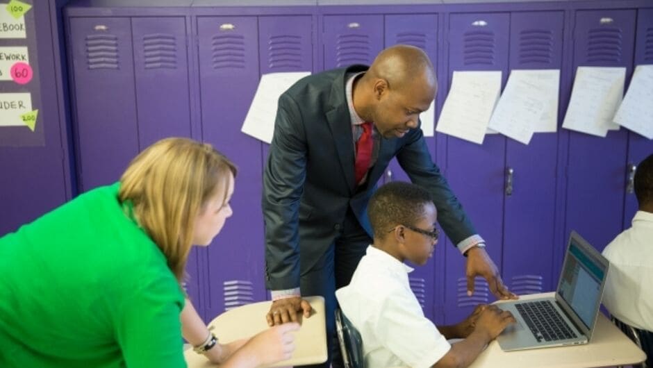 Two Teachers Looking at a Student's Computer