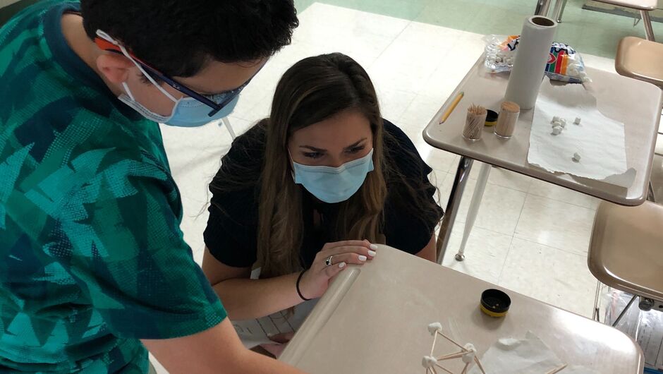 teacher and student building marshmallow tower