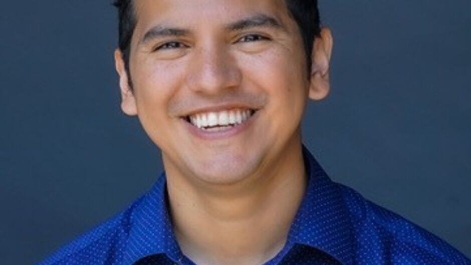 Eddie Zapata wearing a blue shirt and smiling