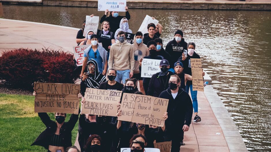 Protestors hold Black Lives Matter signs on the Riverwalk in Pueblo, Colorado.