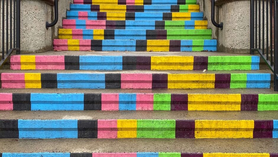 An outdoor set up steps is painted in bright colors. 