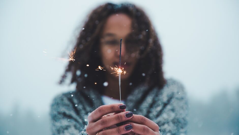 Young person holding sparkler