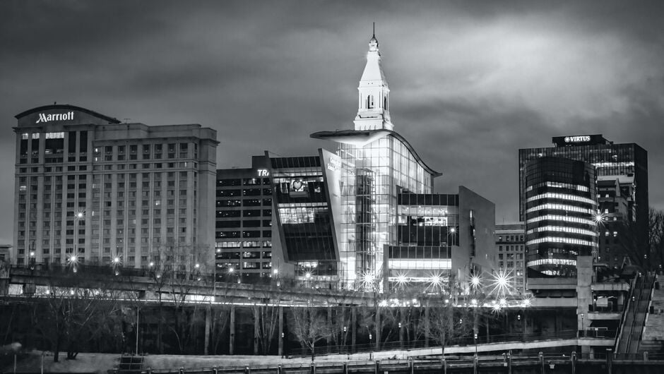 a black and white photo of the Hartford skyline at night.