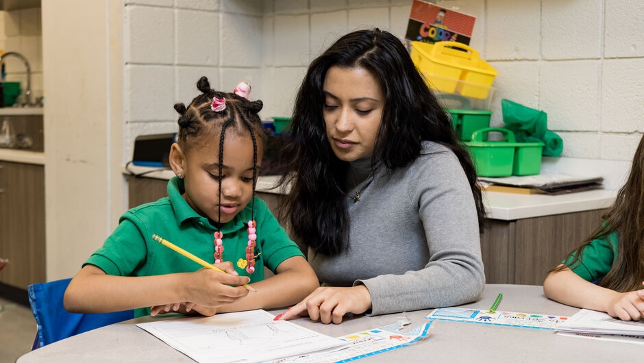Teacher helping student