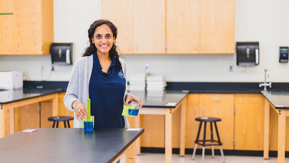A teacher standing in a science lab.