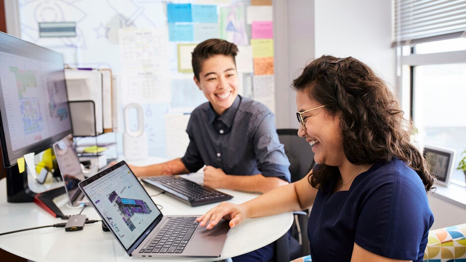 Two teachers working at their computers
