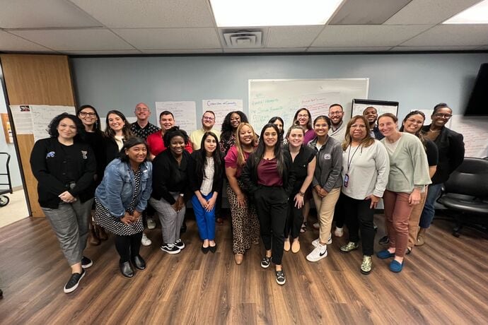 Alt Text: SLLL participants posing for a photo in a classroom.