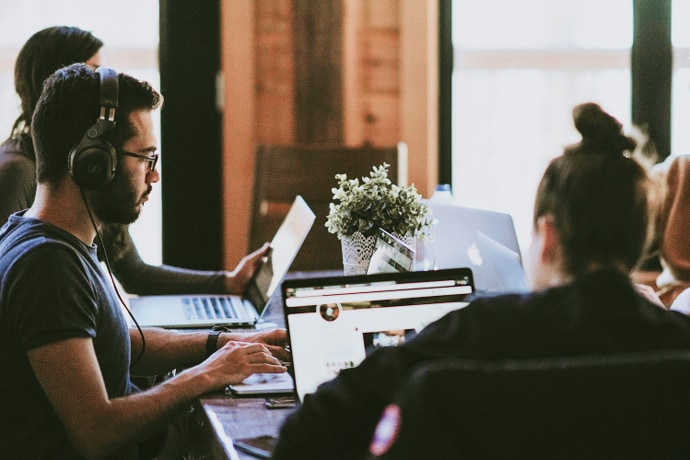 A group of young people working at a coffee shop.