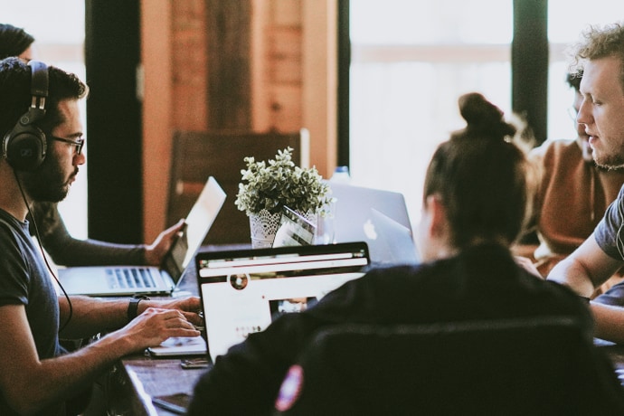 A group of young people working at a coffee shop.