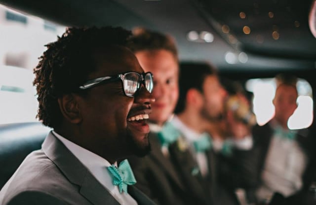 smiling man with sunglasses in limo