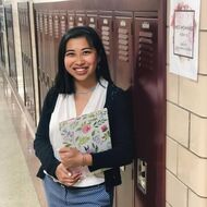 Sarah standing by lockers
