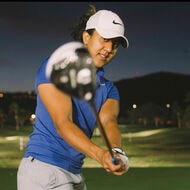 Maya Reddy swinging the golf club toward the camera