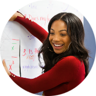 A teacher demonstrates a lesson on the whiteboard.