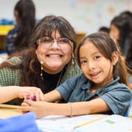 A corps member working with a student