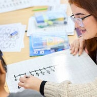 A teacher and student working together in the classroom.