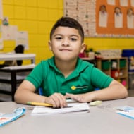 A young student sitting at his desk.